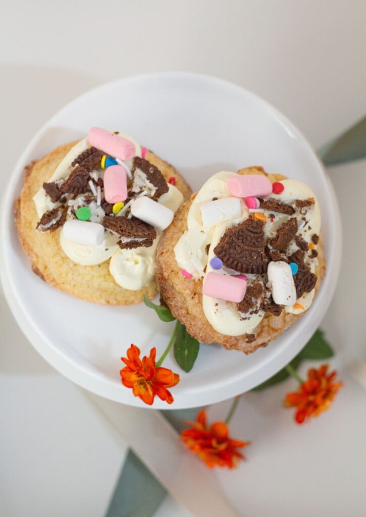 Sugar Cookies - top view of two loaded sugar cookies with marshmallows and Oreo crumble