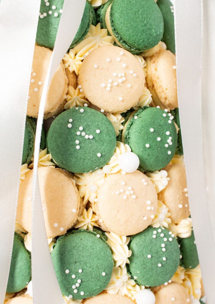 Macaron Dessert Tower - close up of green and ivory macarons with yellow buttercream rosettes