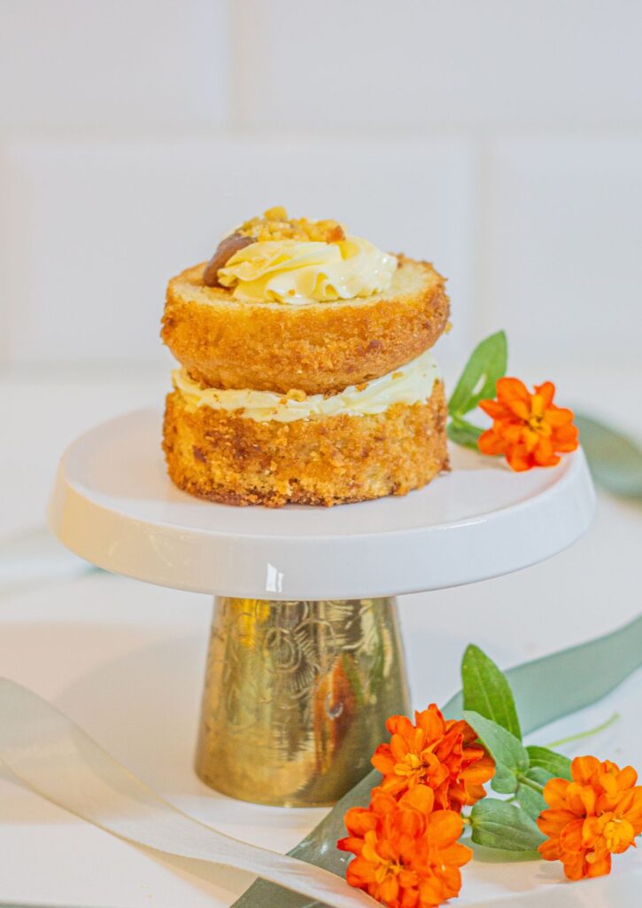 Vanilla Caramel Cake - stacked 8cm mini cake with cookie crumble and vanilla buttercream on gold cake stand